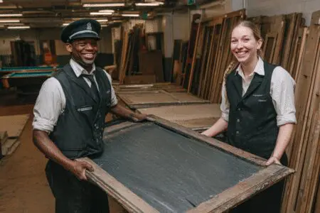 Movers easily carrying a piece of a pool table, showing how to get rid of a pool table