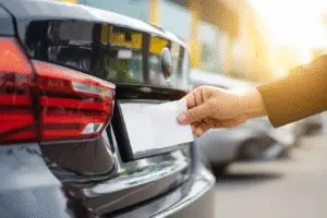 A guide on how to get temporary plates in Texas quickly, showing a paper plate being placed on a car.