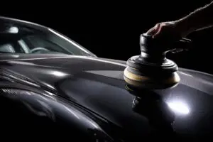 Pro secrets on how to get rid of swirl marks on car paint, showing a before-and-after of a car's paint being polished
