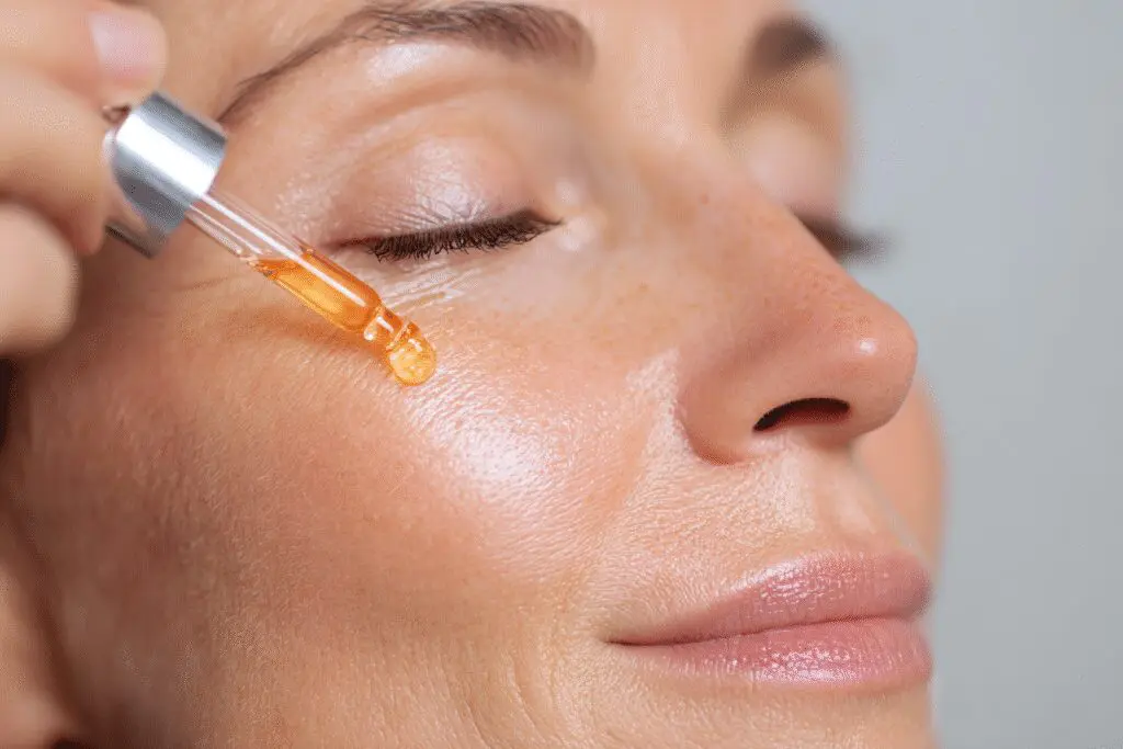 Your complete guide on how to get rid of freckles fast, showing a brightening skincare serum being applied to the face